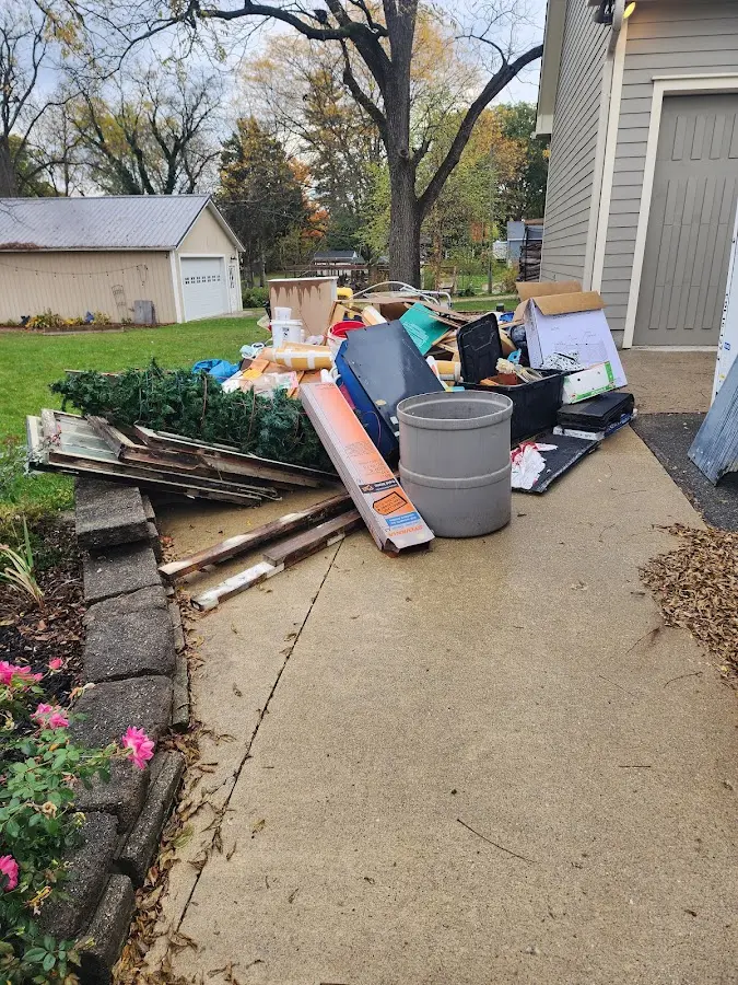 Dumpster being loaded with debris for 12 Yard Dumpster Rental in Harrisonville